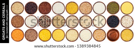 Different cereals, grains and flakes isolated on white background with clipping path, assortment of groats in wooden bowls, top view Royalty-Free Stock Photo #1389384845