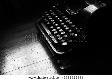 Vintage equipment journalist, publicist, writer typewriter machine. Antique typewriter on wooden table small depth. Black and white style photo. Vintage things writer. Rare objects