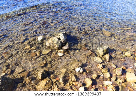 Stones in water, Water edge. Nautical background. 