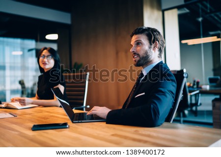 Surprised male financial director feeling shocked from received information during meeting in conference room for brainstorming on strategy, intelligent colleagues communicating during working process Royalty-Free Stock Photo #1389400172