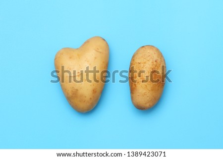 Two potato and heart on a blue paper. Funny root for holiday