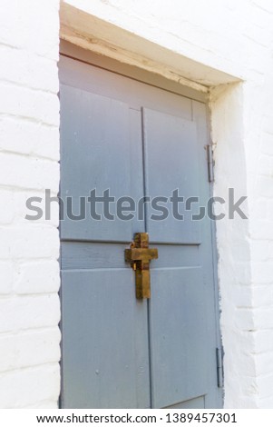 Wooden old door with a christian cross. The concept of religiosity, the path to God.