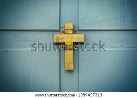 Golden christian old cross on wooden background. Symbol of religion, faith in God.