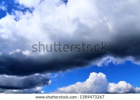 Dark forming clouds on a blue sky right before a rain shower