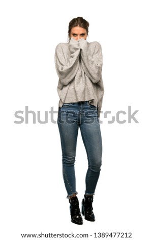 A full-length shot of a Blonde woman with turtleneck freezing over isolated white background