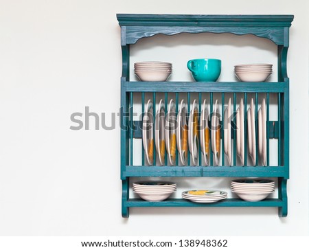 Plate and bowl rack in a cottage kitchen Royalty-Free Stock Photo #138948362