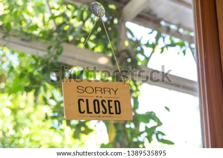 sorry we are closed. closed sign at the shop door. 