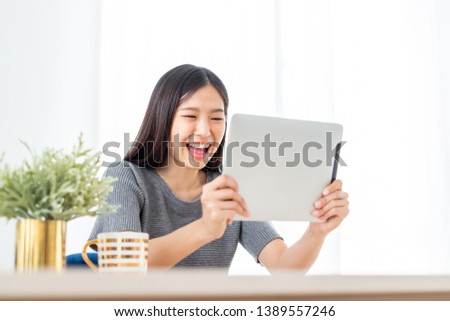 Young Asian woman using internet tablet for online shopping, lifestyle concept