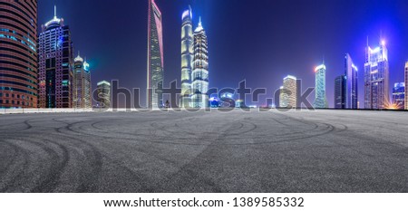 Asphalt race track and modern skyline and buildings in Shanghai at night,panoramic view