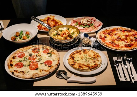 Hot served Italian dishes: Pizza Carbonara and Carpres with Pizza Cutter, Cold Cuts with Burrata Cheese, Puccia with Black Truffle and Linguini Seafood.
