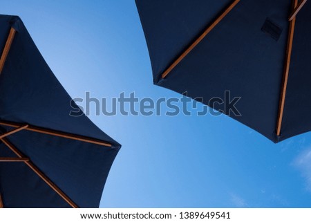 Under the beach umbrellas look up to the sky.