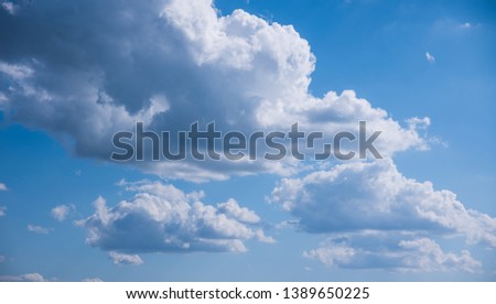 Texture of beautiful spring clouds on the background of blue clear sky