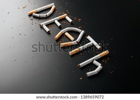 The inscription DEATH from cigarettes on a black background. Stop smoking. The concept of smoking kills. Motivation inscription to quit smoking, unhealthy habit. Smoking as a deadly habit, nicotine po