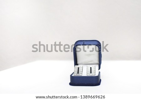 Classic blue box with man's cufflinks on white background. 