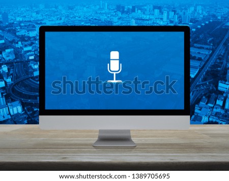 Microphone flat icon on desktop modern computer monitor screen on wooden table over city tower, street, expressway and skyscraper, Business communication online concept