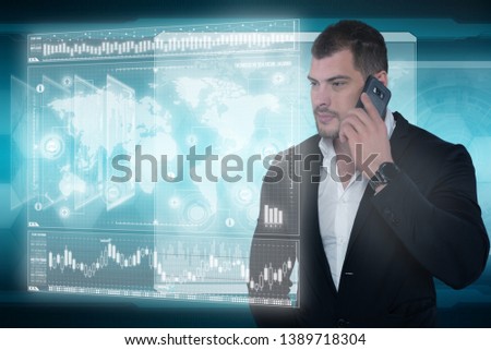 Serious business man speaks on the phone and works in futuristic office