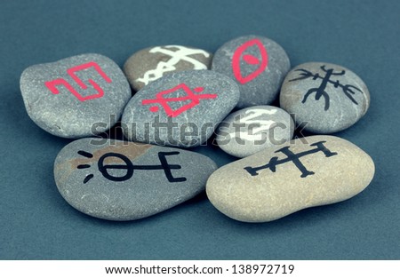 Fortune telling  with symbols on stones on grey background