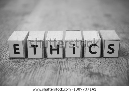 Closeup of word on wooden cube on wooden desk background concept - Ethics