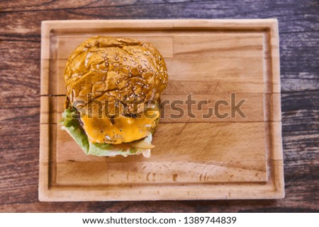 Delicious cheeseburger on the wooden table