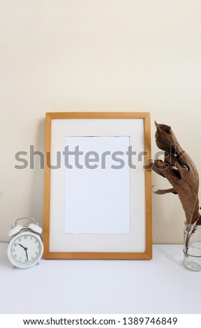 blank vertical wooden frame styled with clock