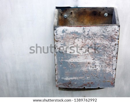 grunge texture of grey metal fence with letterbox on the right