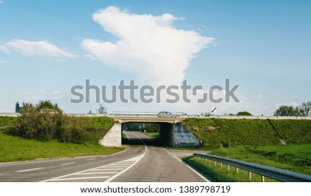 Driver POV at the passage tunnel under French highway with cars driving fast above the passage tunnel