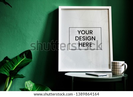Frame mockup with a green wall Royalty-Free Stock Photo #1389864164