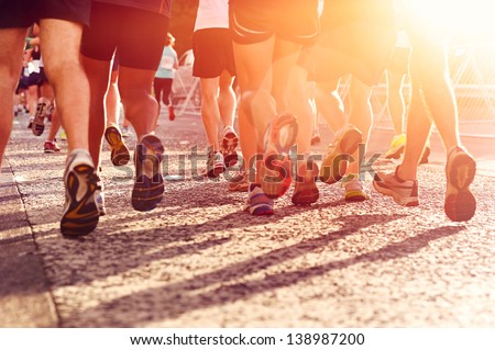 Marathon running race people competing in fitness and healthy active lifestyle feet on road Royalty-Free Stock Photo #138987200