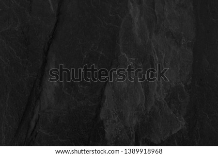 Dark grey black slate background, black stone surfaces.
