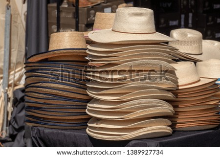 a pile of cowboy hats for sale