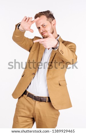 man framing photograph using fingers on white background