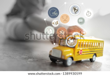 Little boy playing with yellow school bus toy model .Education concept.
