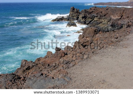 Panorama of Los Hervideros National Park and coastline of Atlantic ocean, Lanzarote, Spain 