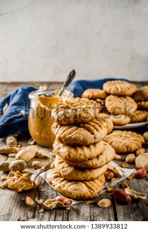 Traditional american baking, homemade Peanut Butter Cookies with peanuts and peanut butter on rustic wooden table