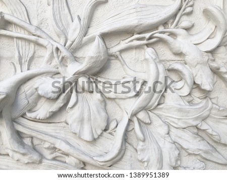 Low relief cement Thai style handcraft of flower stucco.
