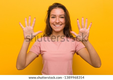 Young european woman isolated over yellow background showing number ten with hands.