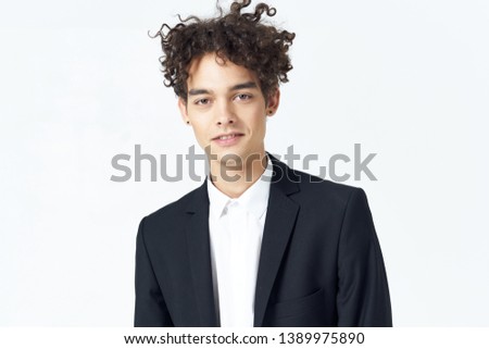 handsome business man in a black jacket curly hair bright background office model