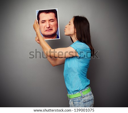 young woman kissing the photo of depressed man