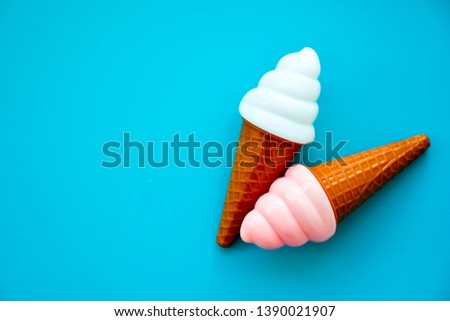 Pink  and  white Toy Ice Cream cone  Isolated on  blue Background. Empty space for text
