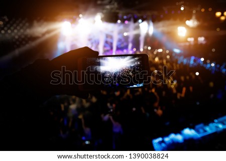 Show on stage. Shooting on mobile phone