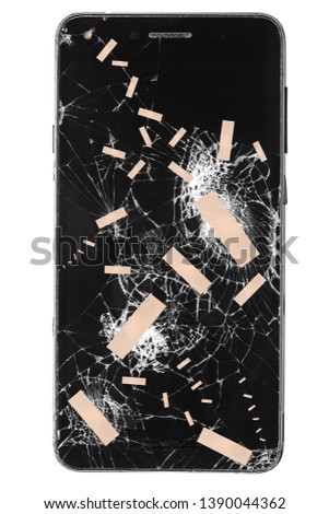 Broken mobile phone / cellphone / smartphone  screen with patch stitches isolated on white background