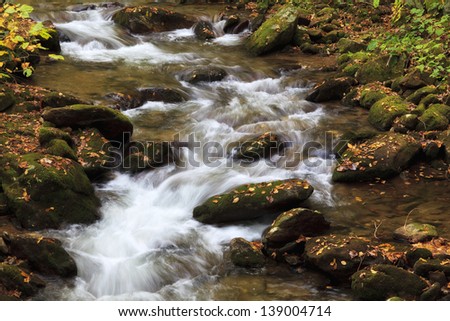 Creek Water Running over Rocks and Boulders