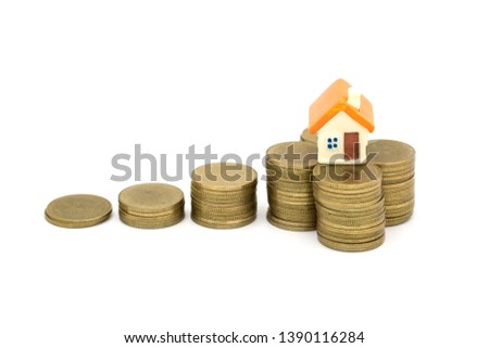 Mini house on stack of coins,Money and house, Real estate investment, Save money with stack coin, Mortgage concept, Real estate growth.  isolated on white background.