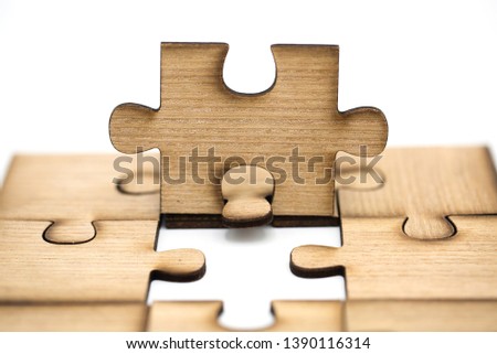 Placing missing a piece of puzzle. business concept,  pieces of wooden jigsaw are connected together isolated on white background. concept of connecting.