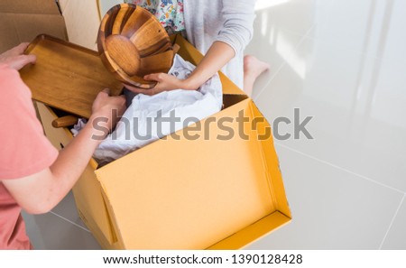 Couple buy a new home. Moving appliance and clothes into the house.