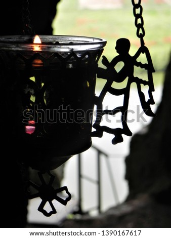 The flame of a candle with an angel with its wings open - a Christian religious symbol