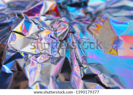 Holographic iridescent foil texture background. It can be used for posters, cards, flyers, brochures, magazines and any kind of cover 