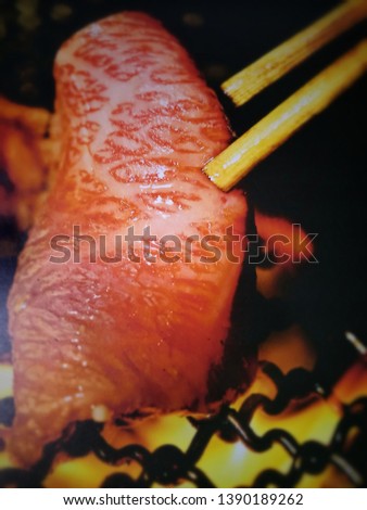 Blurred background and grilled meat in the oven