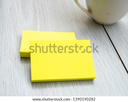 mock up business yellow cards with cup coffee on wood