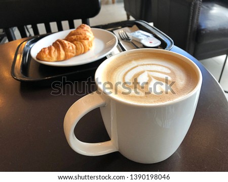 Cup Coffee latte  on white ceramic and Kransong stock photo,Stylish Latte Coffee for breakfast